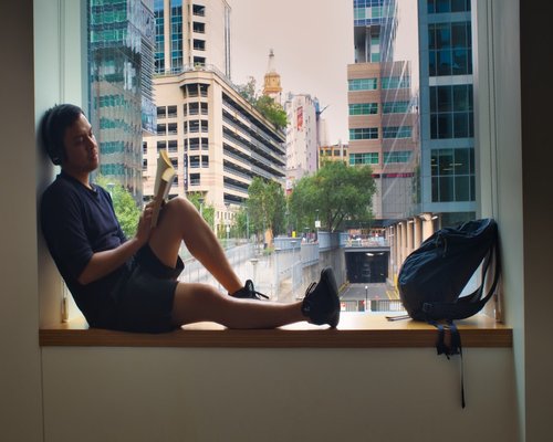 Person looking out a window relaxing